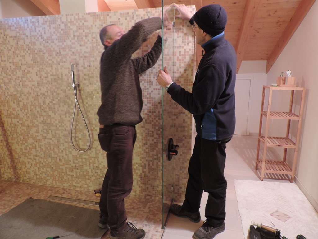 momento del fissaggio del primo vetro fisso con i morsetti avvisati nel muro